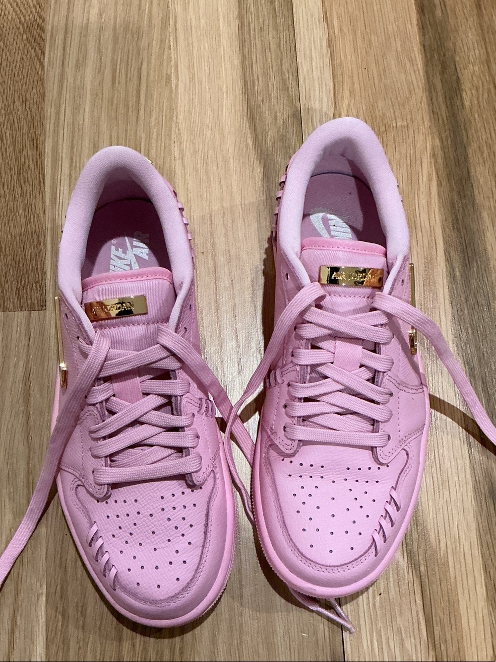 Nike Women’s Pink Low-Top Sneakers with Gold Accents